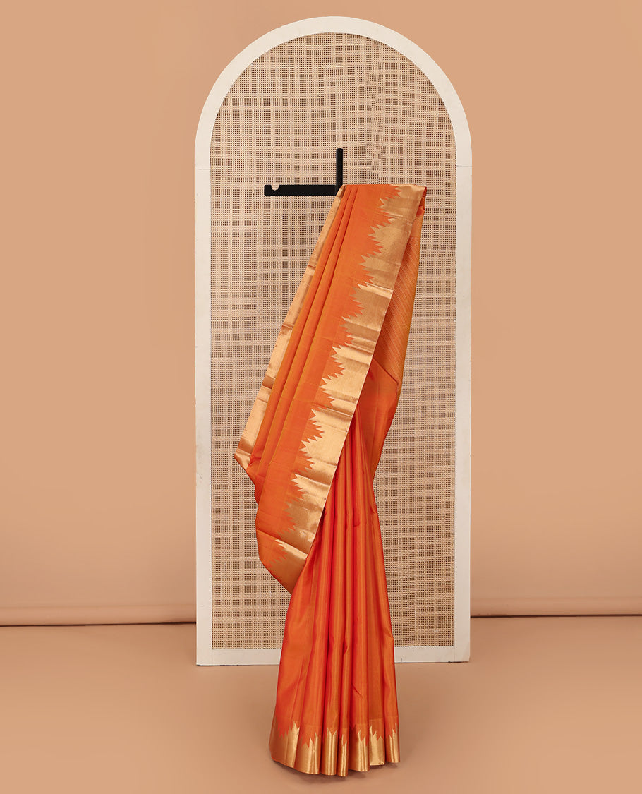 Orange plain Kanchipuram silk saree, thazampoo rekku zari border, and diagonally woven geometric patterned pallu