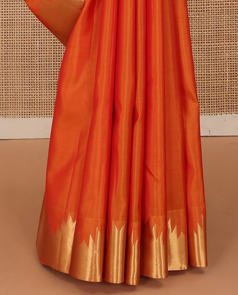 Orange plain Kanchipuram silk saree, thazampoo rekku zari border, and diagonally woven geometric patterned pallu