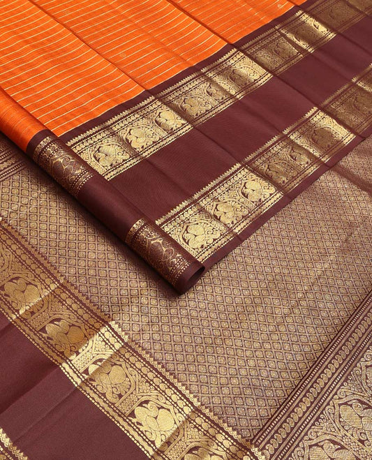 Orange zari buttas and stripes Kanchipuram silk saree, contrast rettai pettu border of thilakam mokku, muthu, manga, and mayil designs, and jaal pallu