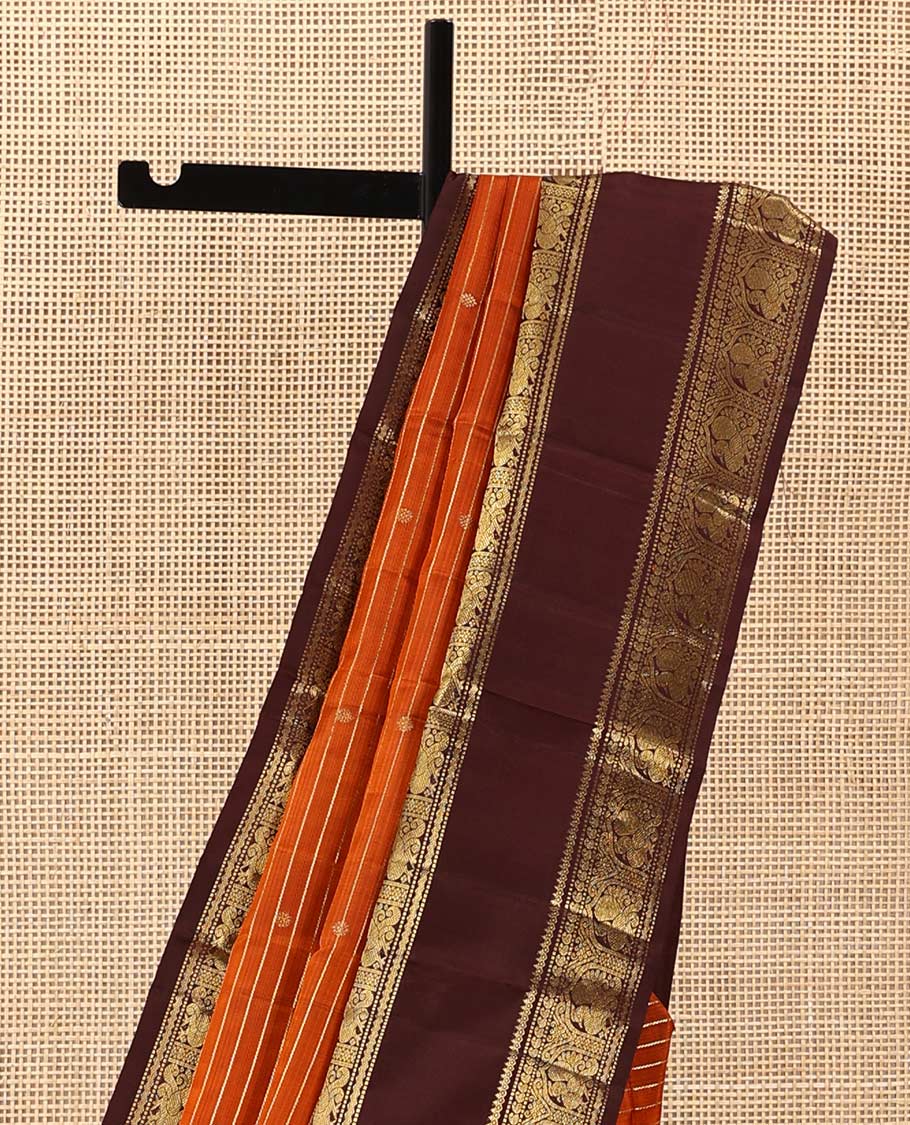 Orange zari buttas and stripes Kanchipuram silk saree, contrast rettai pettu border of thilakam mokku, muthu, manga, and mayil designs, and jaal pallu