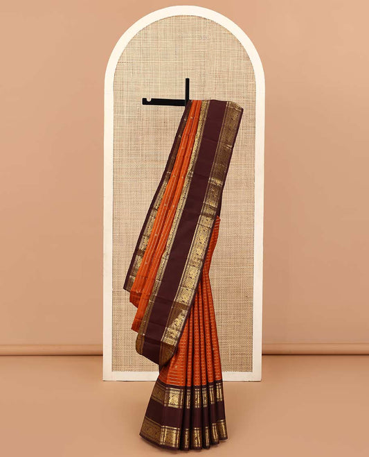 Orange zari buttas and stripes Kanchipuram silk saree, contrast rettai pettu border of thilakam mokku, muthu, manga, and mayil designs, and jaal pallu