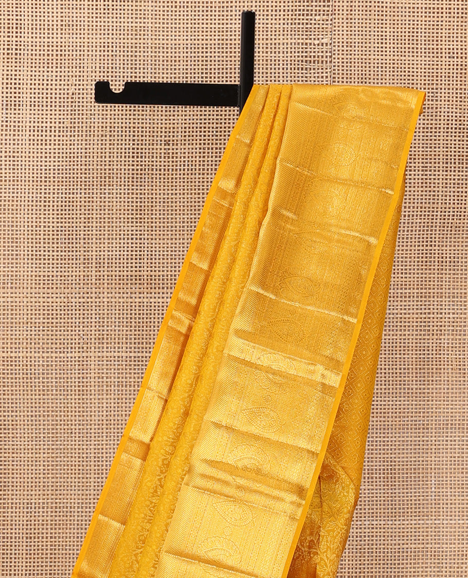 Yellow floral jaal jacquard wedding silk saree, traditional zari design border, and jaal design pallu