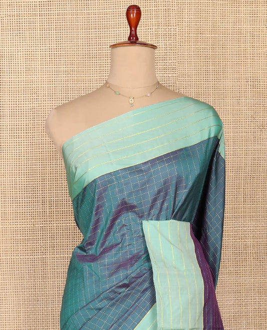 Blue Aarani Silk Saree, Dazzled with Butta Enclosed Checked Design on Its Body, Complemented by a Contrast Zari Striped Border, Pallu of Butta Enclosed Checks, and Paired with a Matching Blouse