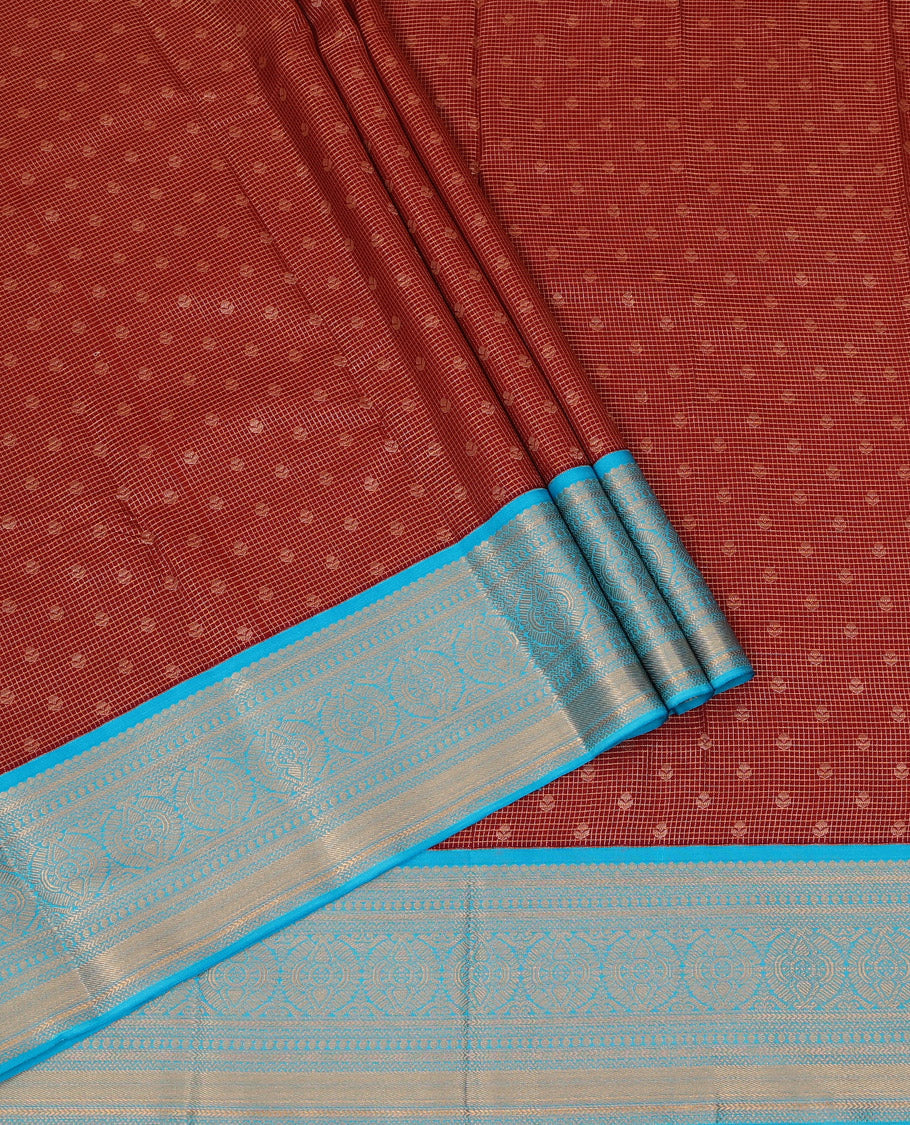 Maroon Art Silk Pavadai Material Set, Detailed with Zari Buttas and Zari Checks All Over Its Skirt, Highlighted with a Contrast Traditional Zari Design Border, and Paired with a Contrast Blouse