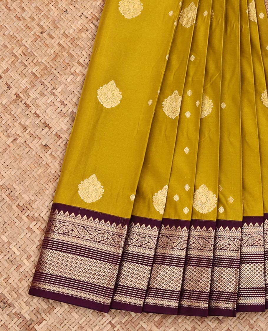 Green Budget Silk Saree, Detailed with Zari Buttas All Over Its Body, Complemented by a Contrast Zari Border of Traditional Designs, Pallu Steeped with Geometric Designs, and Paired with a Contrast Blouse