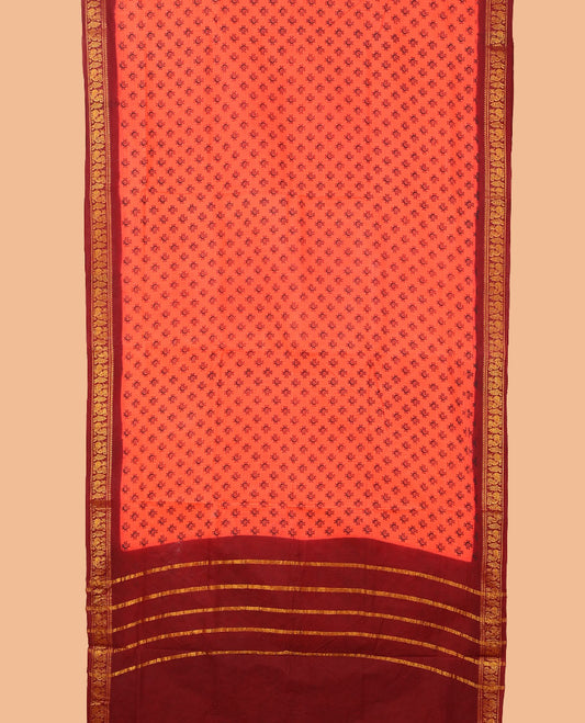 Orange buttas nine-yard cotton saree, contrast traditional zari border, and zari striped pallu
