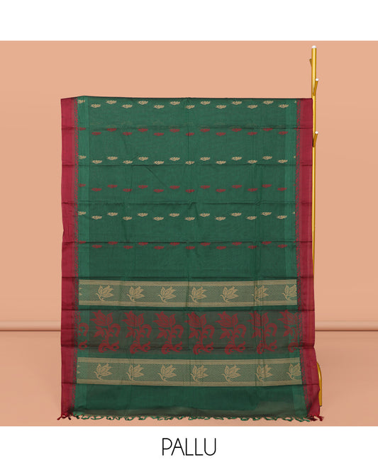 Green Kanchi Cotton Saree, Accentuated with Buttas All Over Its Body, Complemented by a Contrast Border, Pallu of Floral Design, and Paired with Matching Blouse