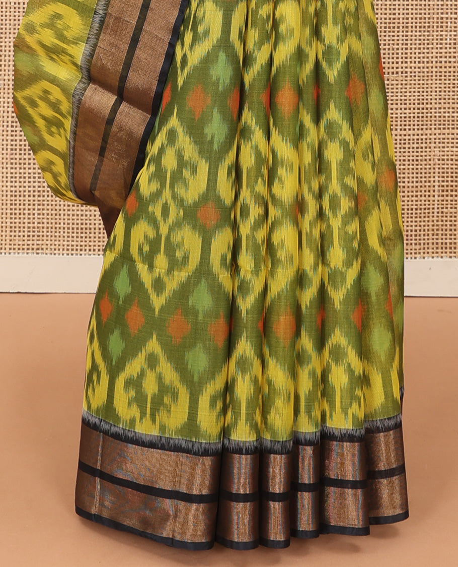 Green Pochampally Ikkat-style ogee patterned silk cotton saree, contrast bavanji zari border, and ikkat design pallu