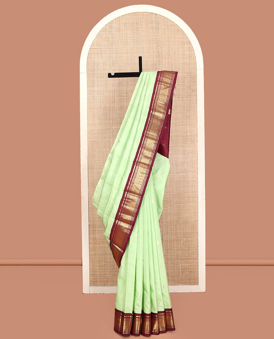 Green Kanchipuram Silk Saree, Graced with Zari Buttas, Contrast Korvai Border of Thilakam Mokku, Banaras, Muthu, and Jaal, Zari Design Pallu, and No Blouse