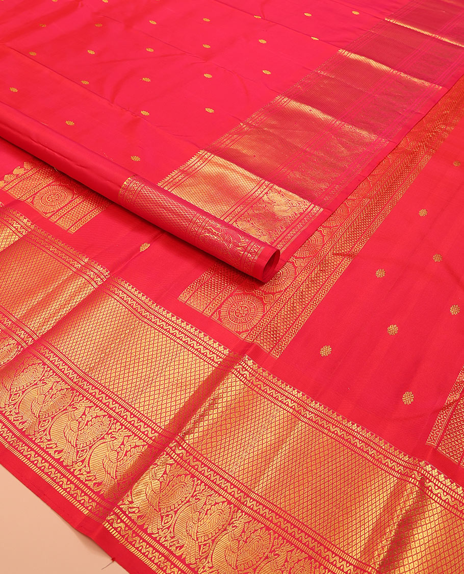 Red zari buttas Kanchipuram silk saree, zari border of muthu, neli, mayil, and mayil kann designs, and chakram design pallu