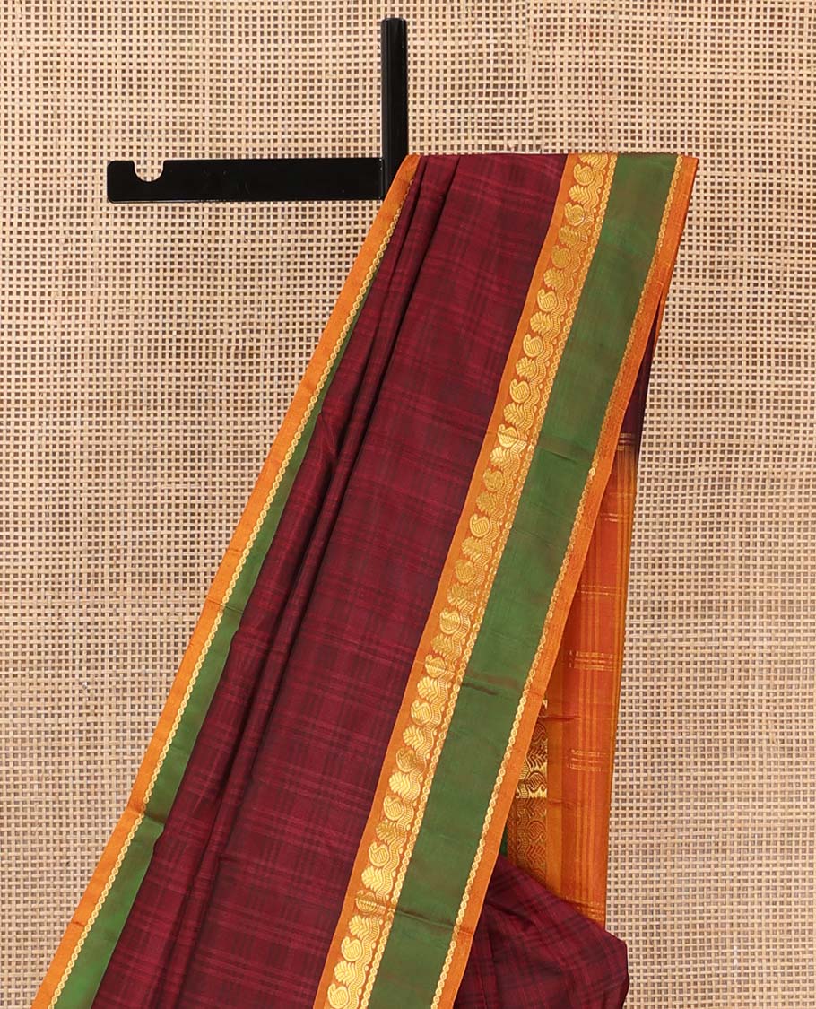 Red checked Kanchipuram silk saree, contrast rettai pettu border of manga, neli, and mayil kann designs, and striped pallu