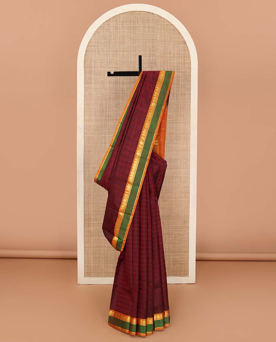 Red checked Kanchipuram silk saree, contrast rettai pettu border of manga, neli, and mayil kann designs, and striped pallu