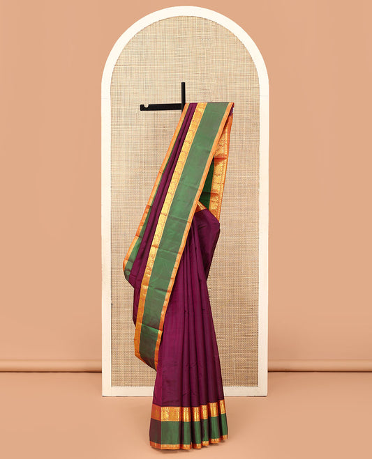 Purple plain Kanchipuram silk saree, contrast rettai pettu border of manga, muthu, and mayil designs, and zari striped pallu