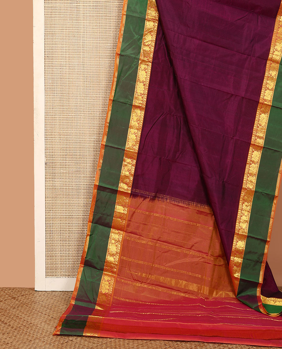 Purple plain Kanchipuram silk saree, contrast rettai pettu border of manga, muthu, and mayil designs, and zari striped pallu