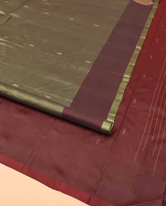 Green Kanchipuram Silk Saree, Adorned with Zari Buttas on Its Body, Complemented by a Contrast Border of Zari Designs, Pallu Pictures Intricate Zari Designs, and Paired with a Contrast Blouse