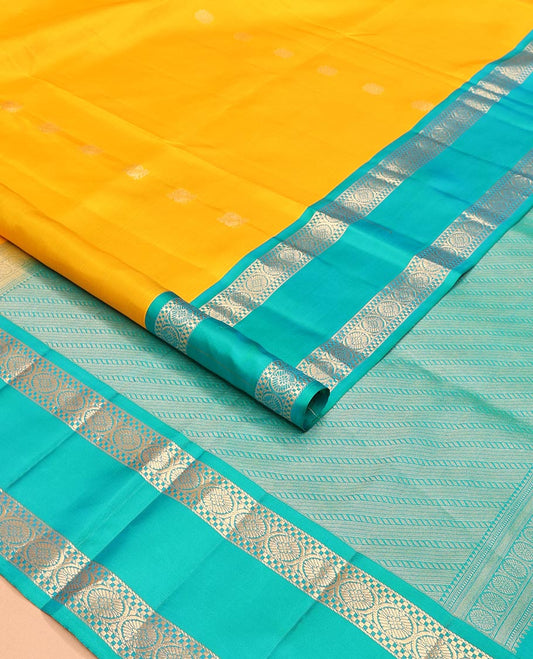 Yellow Mayuri Soft Silk Saree Subtly Sparkled with Zari Buttas All Over the Body, Complemented by a Contrast Rettai Pettu Border of Muthu and Chakram Designs, Pallu Steeped with Puli Nagam Designs, and Paired with a Contrast Blouse