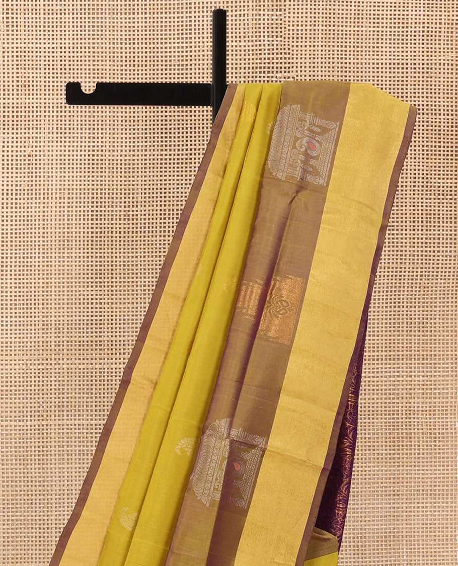 Yellow Uppada Silk Saree Decked Up with Paisley Buttas, Subtle Contrast Border of Temple Gopuram Motifs, Captivating Pallu Featuring Floral Jaal Design, and Paired with a Contrast Blouse