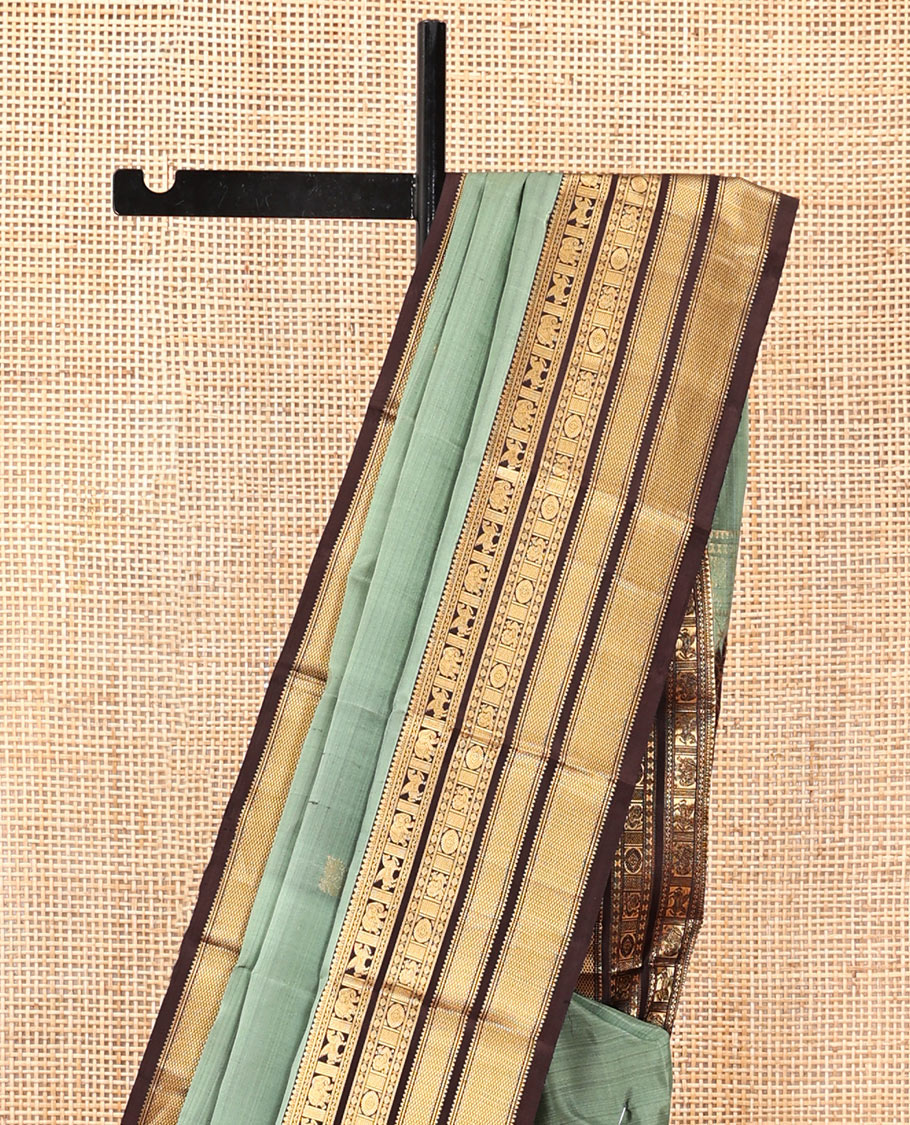 Green Vasundhara Silk Saree, Detailed with Mayil-Chakram Buttas, a Contrast Border of Thikalam, Neli, Kuthirai, Yaanai, Mayil, Chakra, and Mayil Kann, Grand Pallu, and a Contrast Blouse