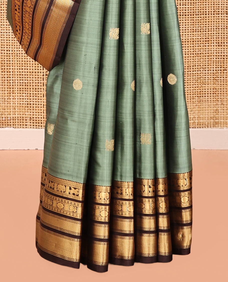 Green Vasundhara Silk Saree, Detailed with Mayil-Chakram Buttas, a Contrast Border of Thikalam, Neli, Kuthirai, Yaanai, Mayil, Chakra, and Mayil Kann, Grand Pallu, and a Contrast Blouse