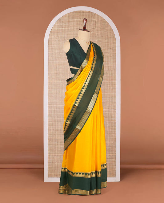 Orange Plain Mysore Silk Saree, Artfully Detailed with Contrast Temple Border of Jaal Designs, Pallu Steeped with Zari Stripes, and Paired with a Contrast Blouse