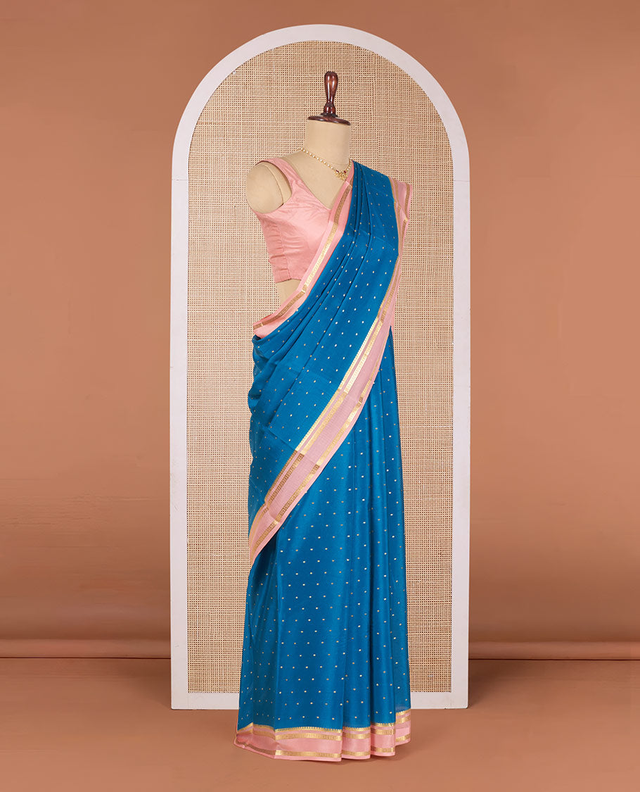 Blue Mysore Silk Saree Delicately Woven with Zari Buttas, Complemented by a Contrast Border Featuring Traditional Zari Designs, Pallu Steeped with Zari Stripes, and Paired with a Contrast Blouse