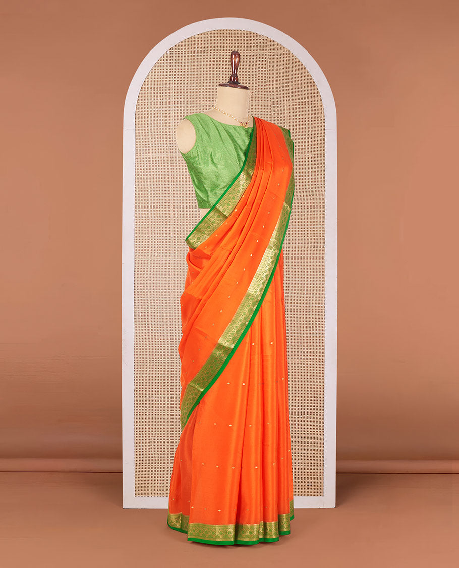 Orange Mysore Silk Saree Enriched with Zari Buttas, Complemented by a Contrast Border Featuring Paisley Zari Designs, Pallu Steeped with Zari Stripes, and Paired with a Contrast Blouse