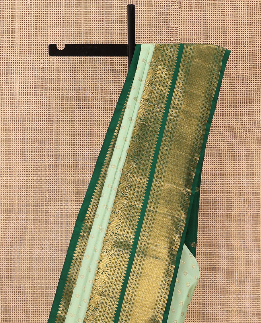 Green kamalam buttas Kanchipuram silk sareee, contrast korvai border of thilakam mokku, kathir, rudraksham, mayil, yaali and jaal design, and zari motifs pallu