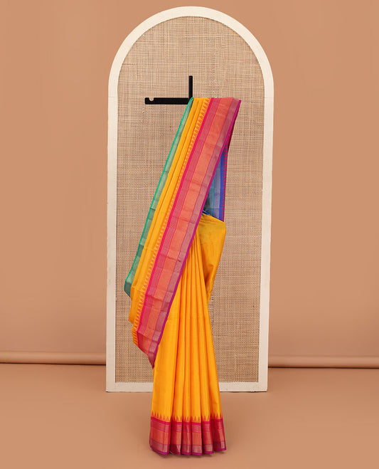 Yellow striped Bangalore silk saree, contrast ganga jamuna temple border, and temple design pallu