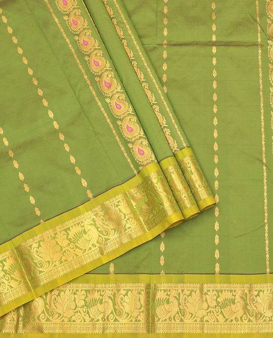 Green Art Silk Pavadai Material Set Featuring Zari Designs on Its Skirt, Complemented by a Contrast Traditional Zari Border, and a Matching Blouse
