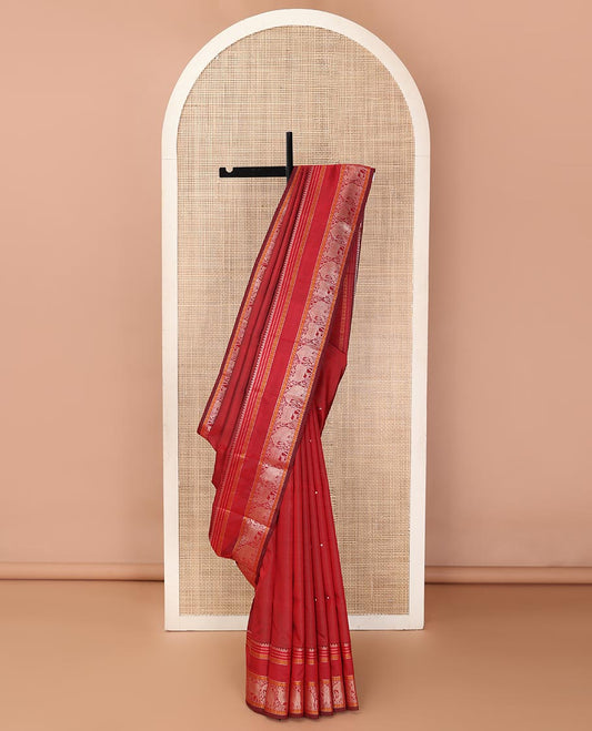 Red thread buttas Kanchipuram silk saree, rettai pettu border of rekku, rudraksham, yaanai, and Pichwai cow designs, and pallu features Vrishabha Kunjara design