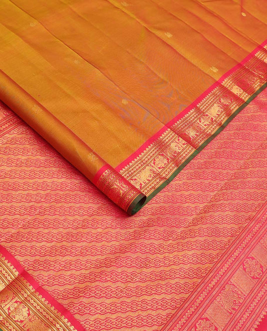 Mustard  Kanchipuram Silk Saree, Elevated with Zari Buttas All Over Its Body, Complemented by Contrast Border of Thilakam Mokku, Banaras, Neli, Manga, and Yaanai Designs, Pallu Steeped with Leaf Motifs, and Paired with a Contrast Blouse