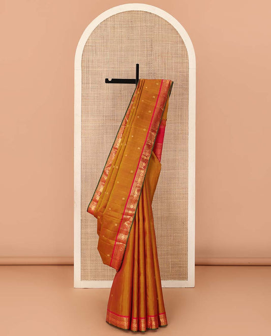 Mustard  Kanchipuram Silk Saree, Elevated with Zari Buttas All Over Its Body, Complemented by Contrast Border of Thilakam Mokku, Banaras, Neli, Manga, and Yaanai Designs, Pallu Steeped with Leaf Motifs, and Paired with a Contrast Blouse