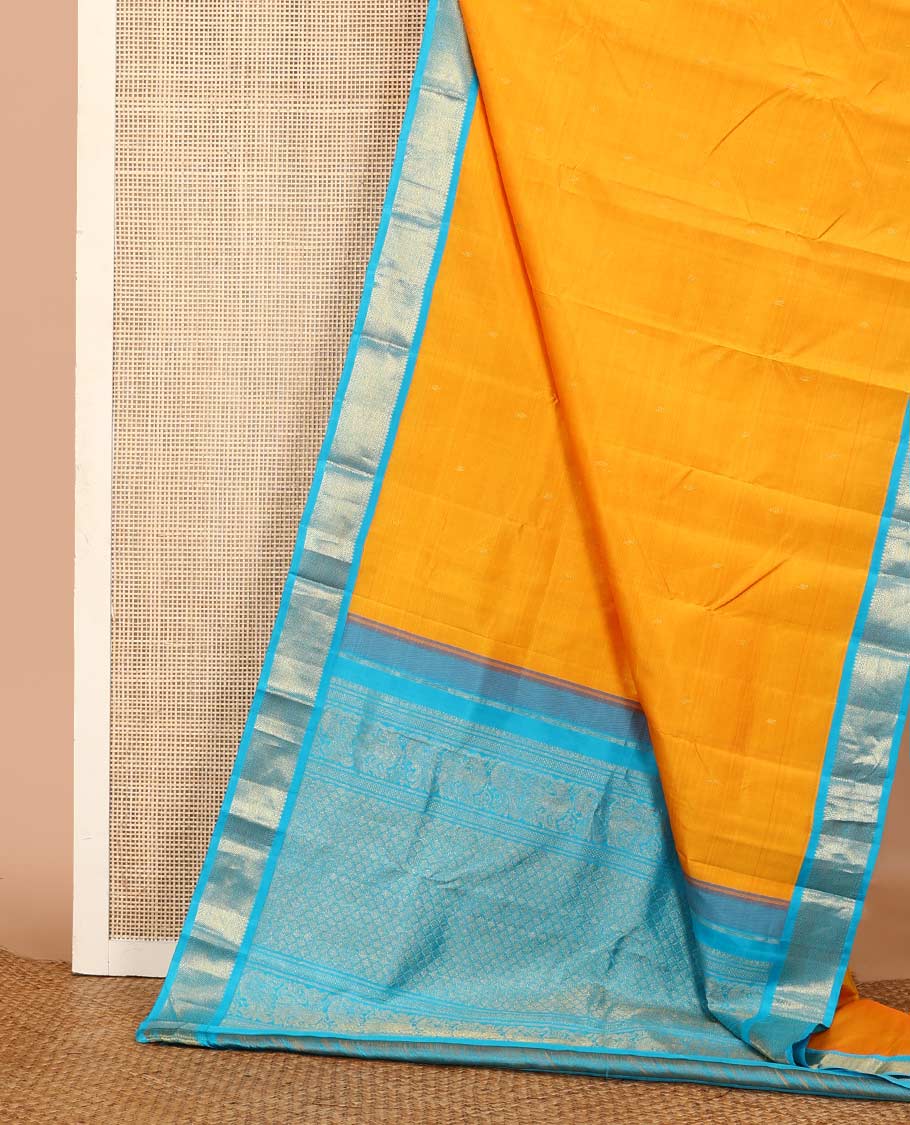 Yellow zari buttas Kanchipuram silk saree, contrast korvai border of thilakam mokku, muthu, and vanki designs, and zari-rich jaal pallu