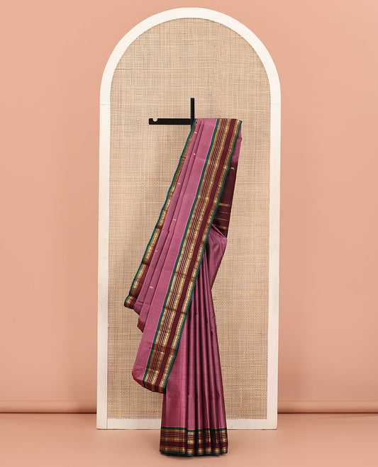 Rosewood Pink Kanchipuram Silk Saree Adorned with Vazhaipoo Stripes and Zari Buttas, Complemented by a Contrast Rettai Pettu Border Featuring Thazampoo Rekku, Muthu, Neli, and Rudraksham Designs, Gleaming Zari Pallu, and Paired with a Contrast Blouse
