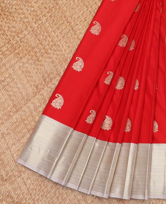 Red Budget Silk Saree Enthralled with Paisley Zari Buttas, Complemented by a Contrast Border Steeped with Traditional Zari Designs, Subtly Designed Jaal Pallu, and Paired with a Contrast Blouse