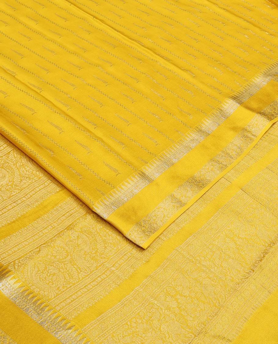 Sandal zari buttas and zig-zag striped crepe saree, traditional zari border, and pallu of traditional design weave