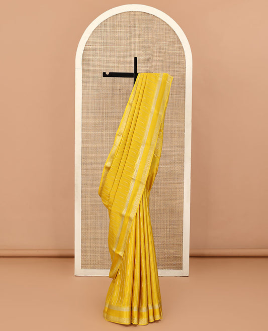 Sandal zari buttas and zig-zag striped crepe saree, traditional zari border, and pallu of traditional design weave