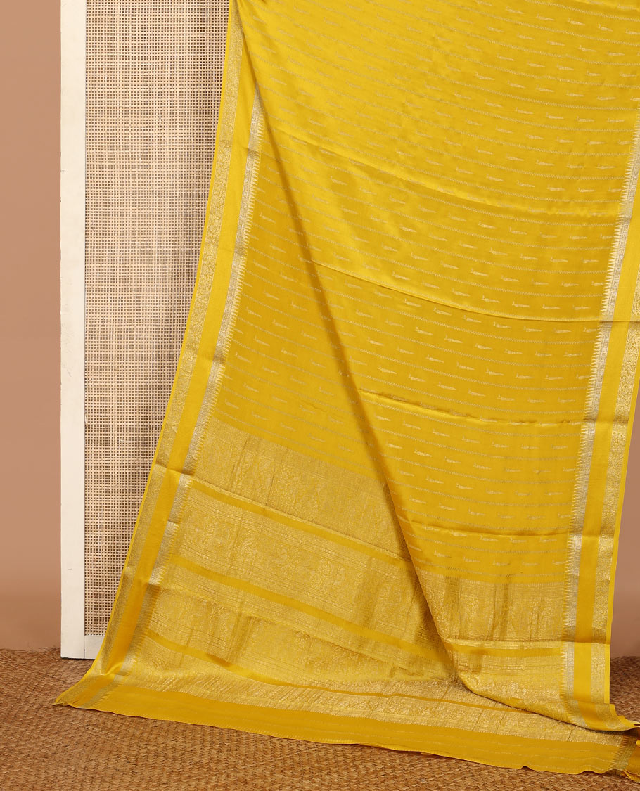 Sandal zari buttas and zig-zag striped crepe saree, traditional zari border, and pallu of traditional design weave