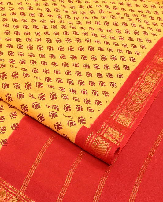 Yellow floral buttas nine-yard cotton saree, contrast traditional zari border, and zari striped pallu