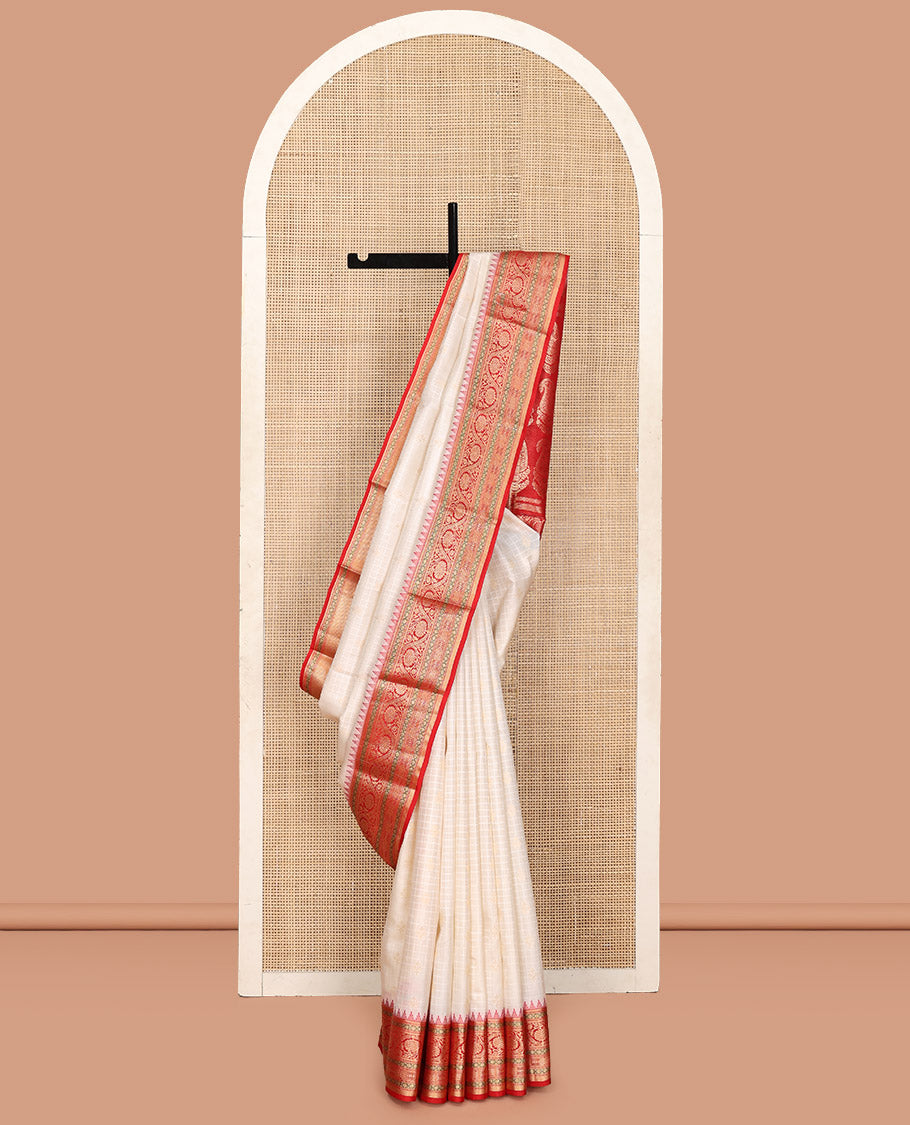 Cream Vasundhara Silk Saree, Subtly Sparkled with Buttas And Checks On Its Body, Complemented by Captivating Contrast Border of Thazampoo Rekku, Muthu, Banaras, and Kodi Visiry Designs, Pallu Steeped with Manga Designs, And Paired with a Contrast Blouse