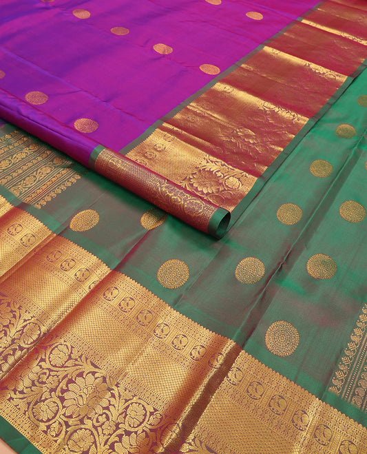 Purple chakram buttas Kanchipuram silk saree, contrast border of thilakam mokku, muthu, rudraksham, mayil, mayil kann, and kodi visiry designs, and chakram motifs pallu