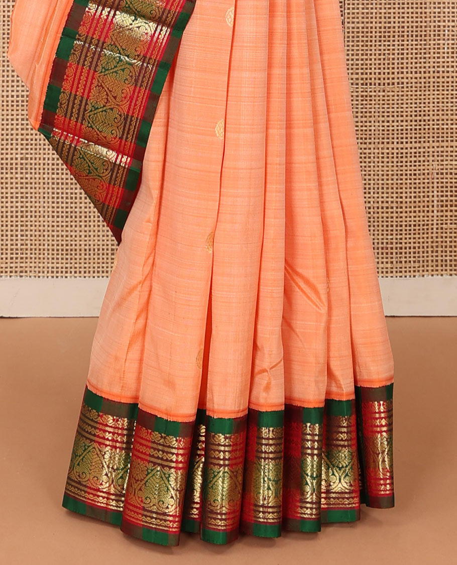 Peach zari buttas Kanchipuram silk saree, contrast one-sided korvai border of neli, and jadai nagam designs, and zari design pallu
