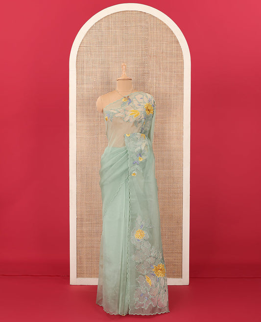 Green tropical floral motifs thread embroidered organza saree, scallop border, and floral embroidered pallu