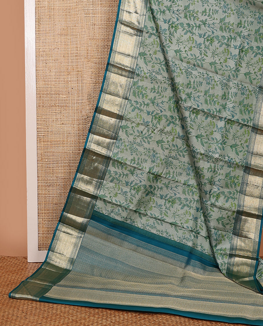 Green leaf printed silk saree, contrast border of thilakam mokku, muthu, diamond, and vanki designs, and jaal pallu