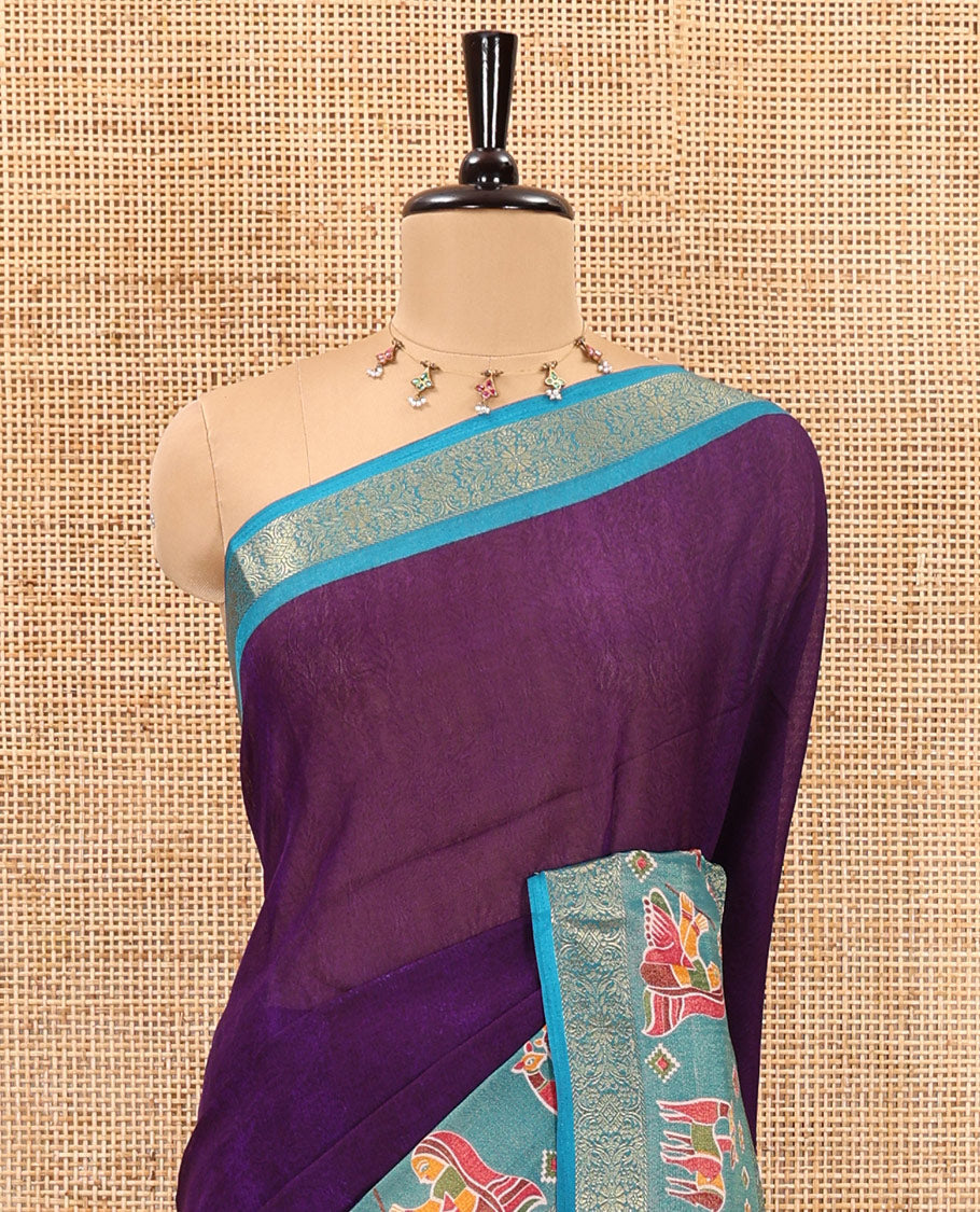 Violet embossed moss chiffon saree, contrast zari and colorfully printed border and pallu of human figurines and Pichwai cows, and embossed blouse