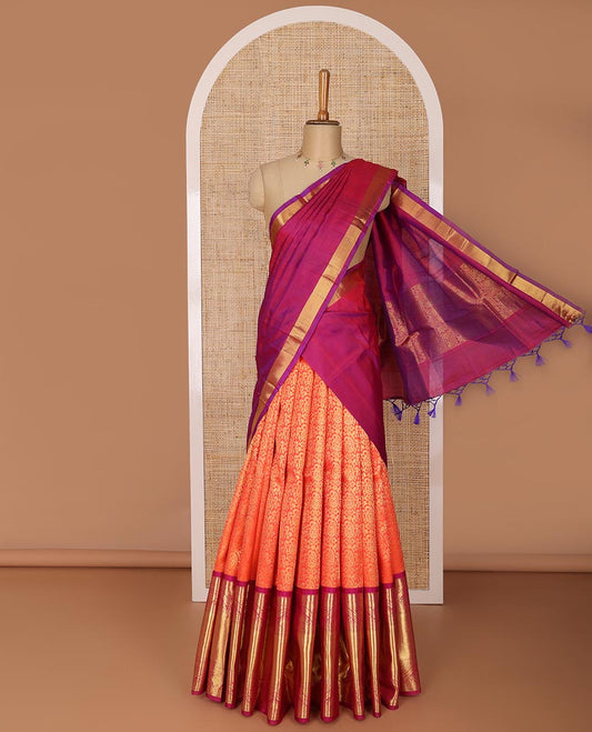 Orange floral jacquard silk half saree with contrast border of thilakam mokku, muthu, paun design, zari design blouse & floral design dhavani