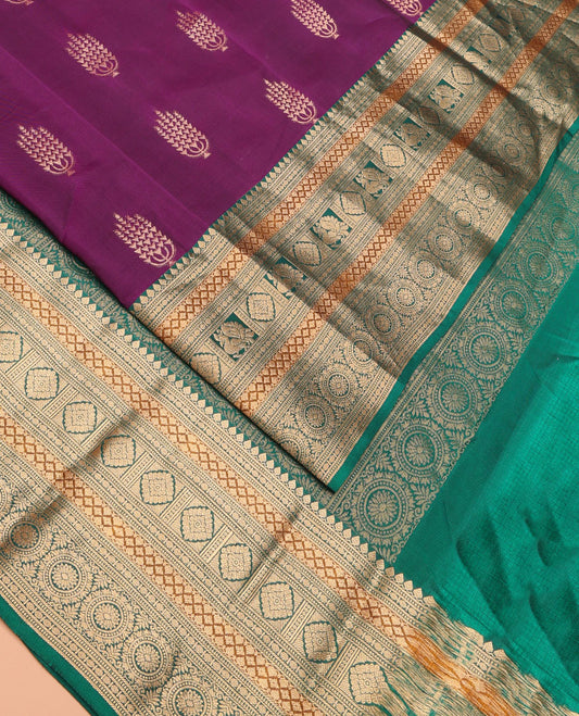 Purple Vasundhara Lite Silk Mix Saree Featuring Layered Deepam Buttas, Complemented by a Contrast Border of Thilakam Mokku, Muthu, Rudraksham, Lavangam, Laddu Kamalam, and Chakram Designs, Pallu Steeped with Chakram Designs, and a Contrast Blouse