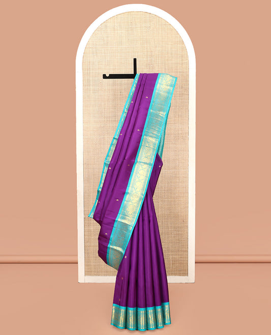 Violet Vasundhara Silk Saree, Subtly Sparkled With Zari Buttas All Over Its Body, Complemented by Zari Buttas All Over Its Body, Complemented by Contrast Border of Thilakam, Banaras, and Mayil Designs Grand Jaal Pallu and Paired with a Contrast Blouse