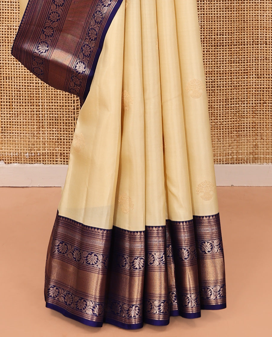 Sandal Vasundhara Silk Saree, Sparsely Sparkled with Zari Buttas, Complemented by a Contrast Border of Thilakam Mokku, Kodi Visiry, and Mayil Kann Designs, Jaal Pallu, and a Contrast Blouse