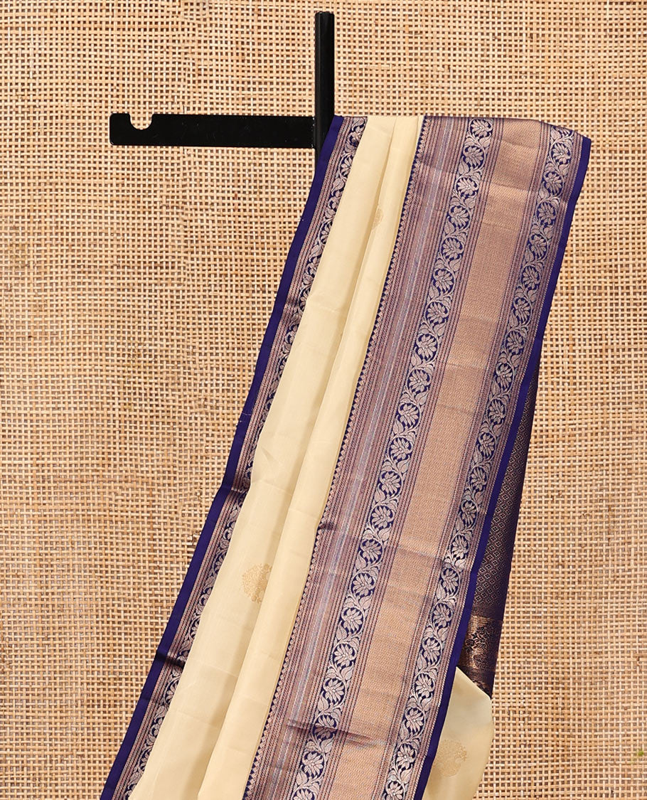 Sandal Vasundhara Silk Saree, Sparsely Sparkled with Zari Buttas, Complemented by a Contrast Border of Thilakam Mokku, Kodi Visiry, and Mayil Kann Designs, Jaal Pallu, and a Contrast Blouse